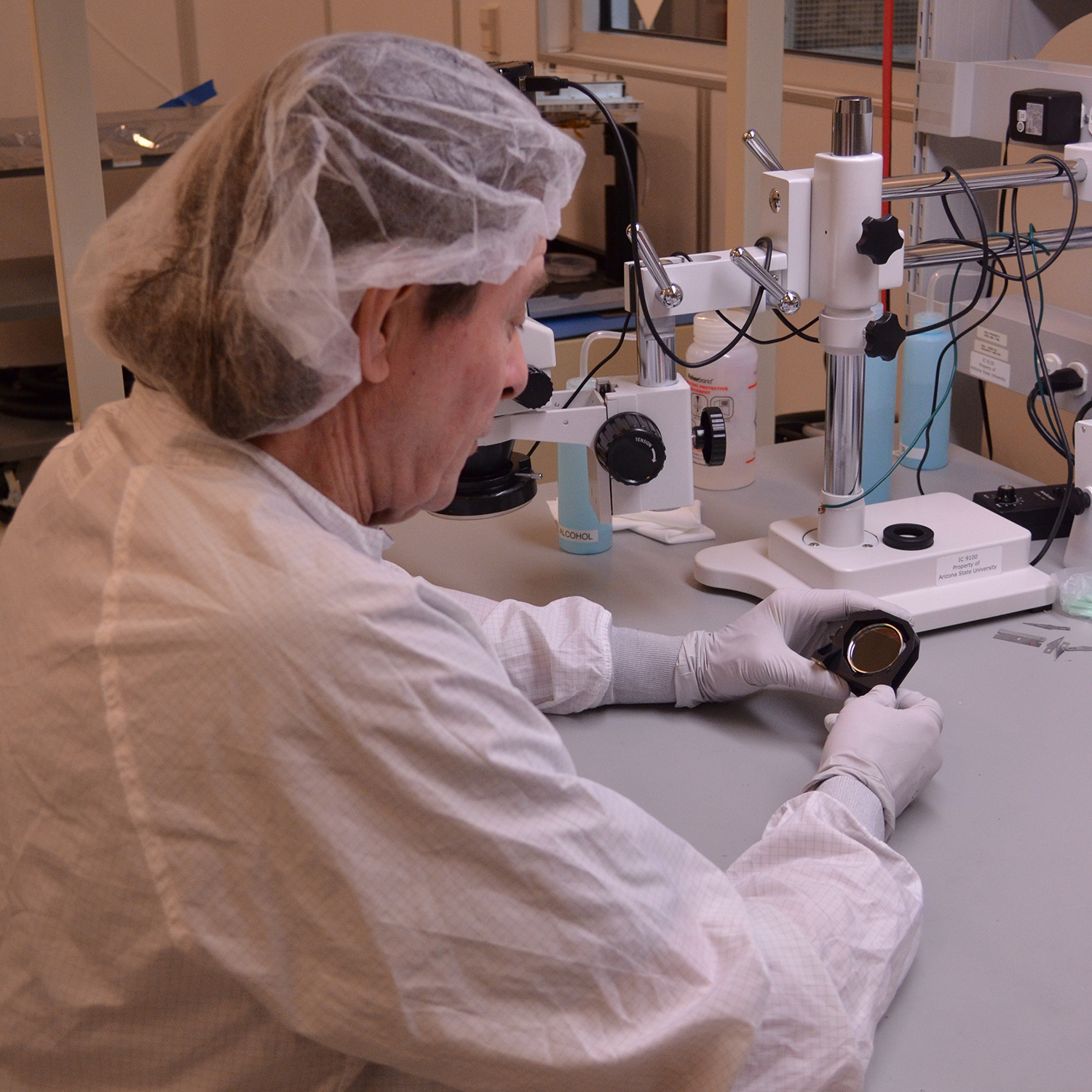 Bill O'Donnell (ASU) inspecting Beamsplitter Assembly to make sure all the bonds are in place.